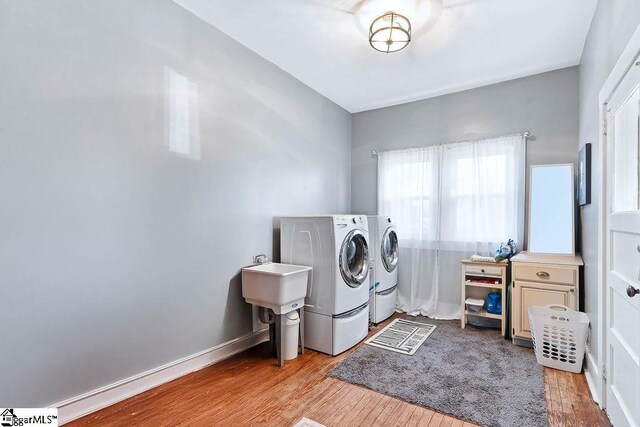 15 S Greenwood Ave, Ware Shoals, SC 29629 - laundry area with washer and dryer, a sink, wood finished floors, and laundry area