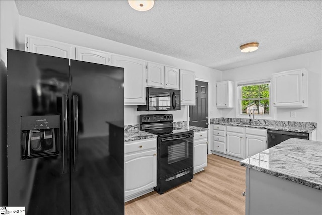 118 Rodney St, Moore, SC 29369 - kitchen featuring light stone countertops, black appliances, a sink, white cabinetry, and a textured ceiling