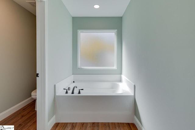 104 Pawleys Ct, Anderson, SC 29625 - bathroom with wood finished floors, a garden tub, toilet, and baseboards