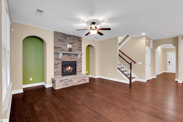 unfurnished living room featuring visible vents, ceiling fan, wood finished floors, and a fireplace