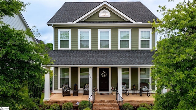 view of front facade featuring a porch and a shingled roof