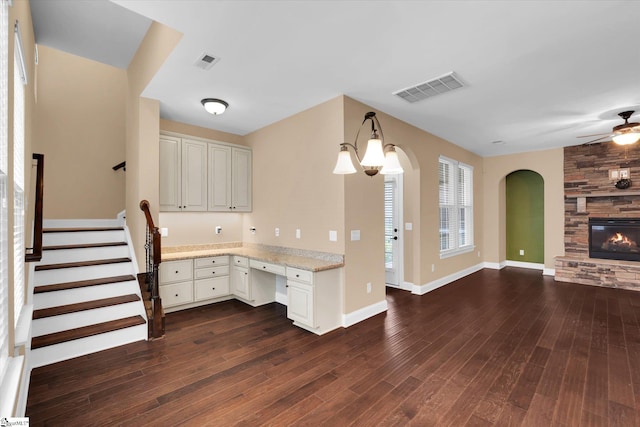 kitchen with visible vents, ceiling fan, open floor plan, and dark wood-type flooring