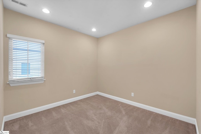 carpeted empty room with recessed lighting, visible vents, and baseboards
