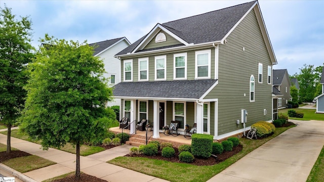 view of front of house featuring a porch and a shingled roof