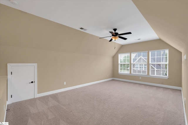 bonus room featuring a ceiling fan, visible vents, vaulted ceiling, light carpet, and baseboards