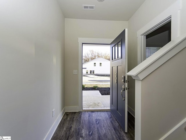 entryway featuring baseboards, visible vents, and dark wood-type flooring