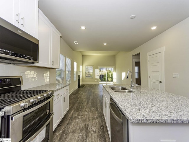 kitchen with recessed lighting, dark wood-style flooring, appliances with stainless steel finishes, and a sink