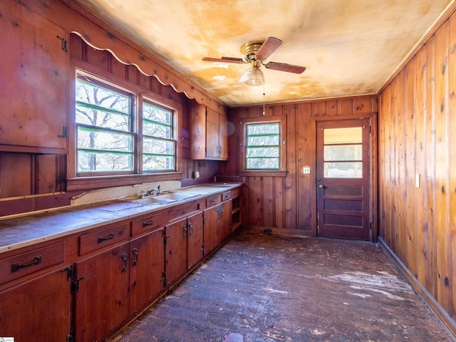 2006 E N St, Greenville, SC 29607 - kitchen featuring a sink, wooden walls, ceiling fan, and brown cabinets