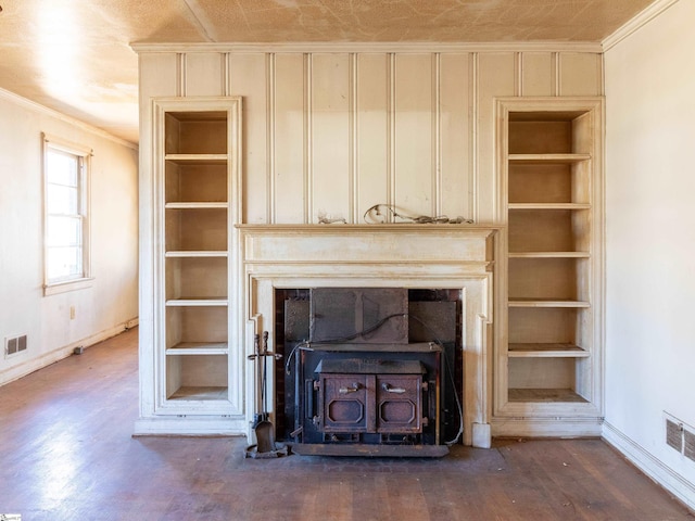2006 E N St, Greenville, SC 29607 - room details with a wood stove, built in features, baseboards, ornamental molding, and wood finished floors