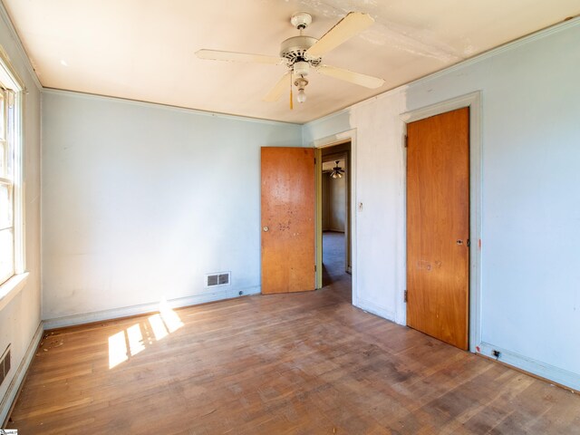 2006 E N St, Greenville, SC 29607 - unfurnished bedroom with crown molding, a ceiling fan, visible vents, and wood finished floors