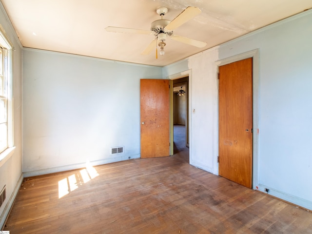 2006 E N St, Greenville, SC 29607 - unfurnished bedroom with crown molding, a ceiling fan, visible vents, and wood finished floors