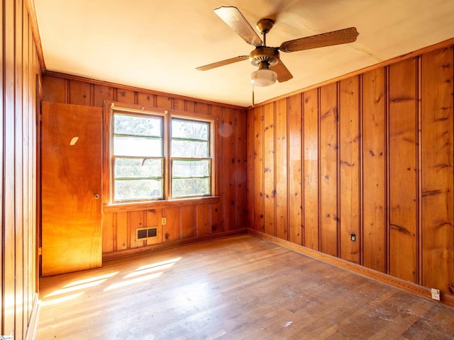 2006 E N St, Greenville, SC 29607 - empty room featuring ceiling fan, visible vents, baseboards, wooden walls, and wood finished floors