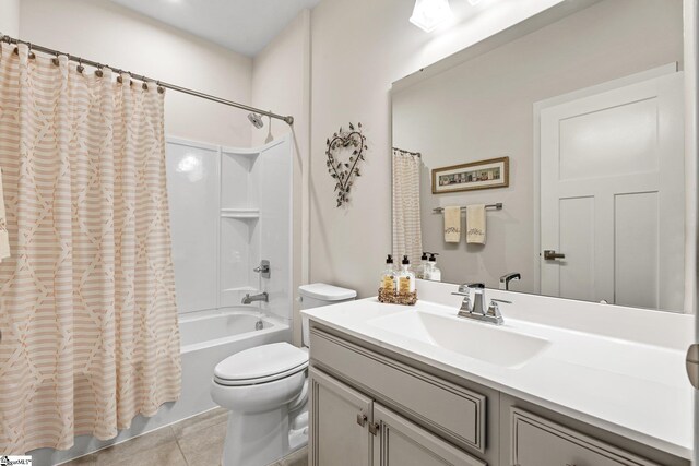 bathroom with tile patterned floors, shower / tub combo, toilet, and vanity