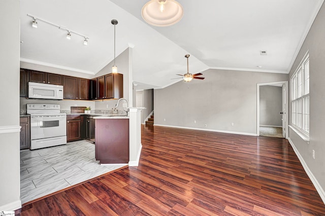 kitchen with white appliances, a peninsula, a ceiling fan, open floor plan, and lofted ceiling
