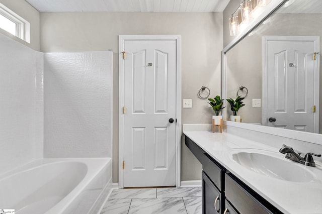 bathroom featuring  shower combination, vanity, and marble finish floor
