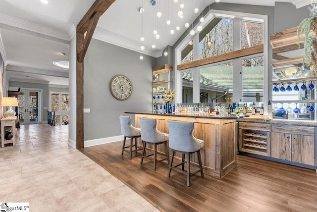 400 Stony Rd, Landrum, SC 29356 - bar with baseboards, ornamental molding, indoor wet bar, and wine cooler