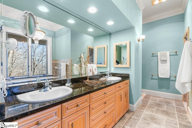 400 Stony Rd, Landrum, SC 29356 - bathroom with crown molding, double vanity, a sink, and baseboards