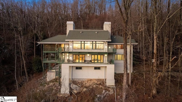 400 Stony Rd, Landrum, SC 29356 - rear view of property with a chimney, a balcony, a shingled roof, and a view of trees