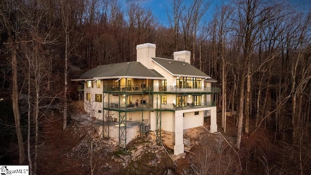 400 Stony Rd, Landrum, SC 29356 - rear view of house featuring stucco siding, central AC, a balcony, and a view of trees