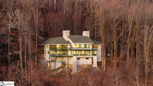400 Stony Rd, Landrum, SC 29356 - rear view of house with a chimney, a balcony, and a forest view