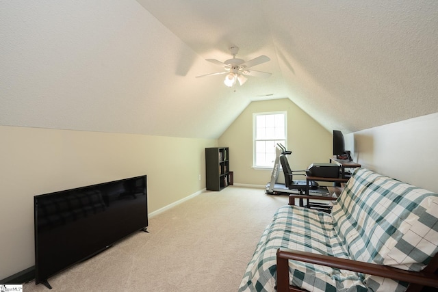 bedroom featuring lofted ceiling, a ceiling fan, baseboards, a textured ceiling, and light colored carpet