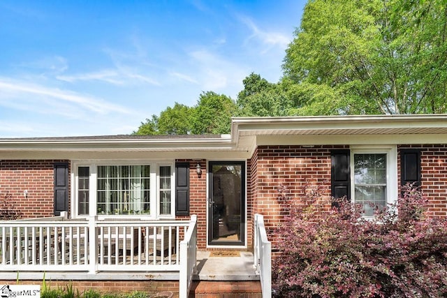property entrance featuring brick siding