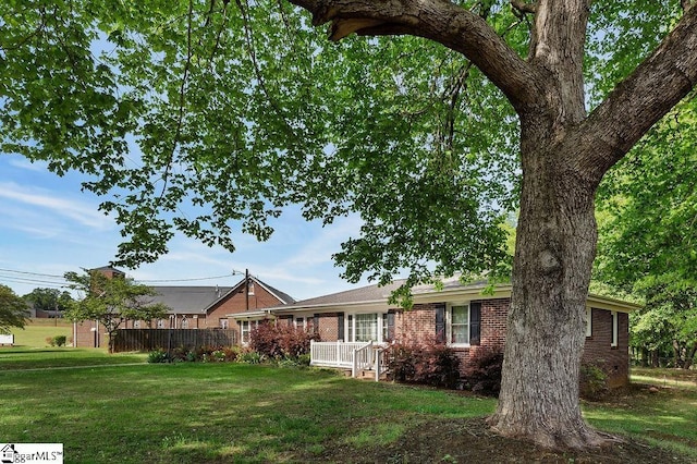 view of front of house featuring a front yard and brick siding
