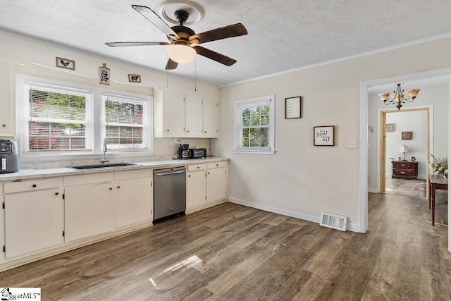 kitchen featuring stainless steel dishwasher, a sink, wood finished floors, and visible vents
