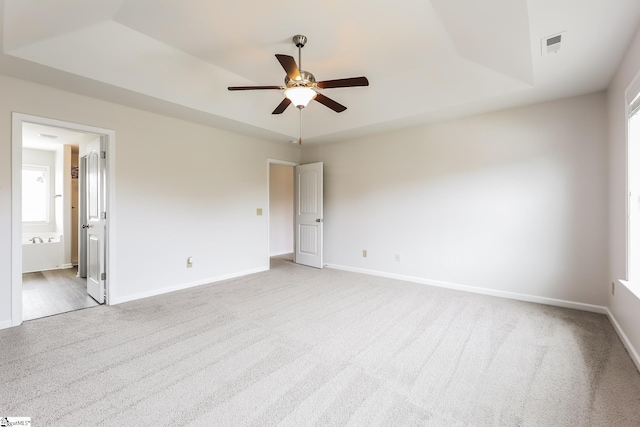 9 Dunsborough Dr, Simpsonville, SC 29680 - unfurnished bedroom featuring connected bathroom, light carpet, baseboards, visible vents, and a raised ceiling