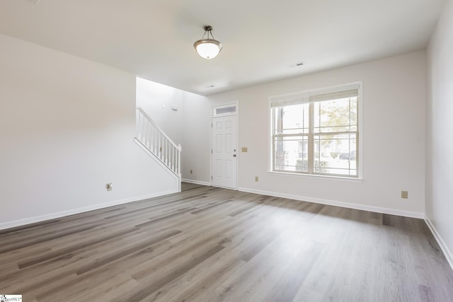 9 Dunsborough Dr, Simpsonville, SC 29680 - unfurnished living room featuring stairway, wood finished floors, visible vents, and baseboards