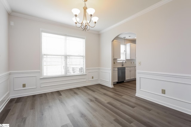 9 Dunsborough Dr, Simpsonville, SC 29680 - unfurnished dining area featuring dark wood-style floors, a notable chandelier, crown molding, arched walkways, and wainscoting