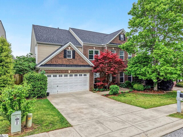 view of front of house featuring brick siding, a shingled roof, driveway, and a front yard
