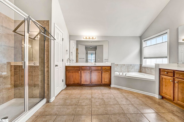 bathroom featuring a stall shower, a garden tub, and vanity