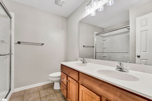 full bathroom with toilet, a shower stall, baseboards, and a sink