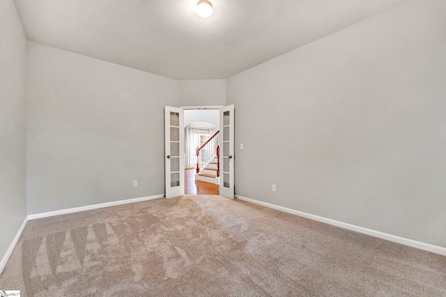 unfurnished room with stairs, carpet flooring, and baseboards