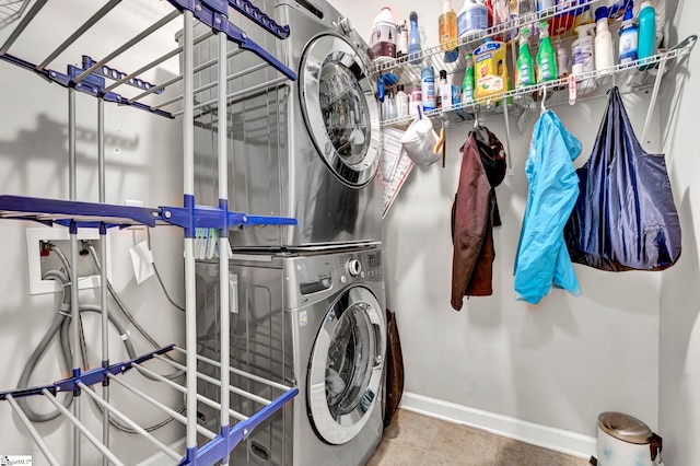 laundry room with stacked washer and dryer, laundry area, and baseboards