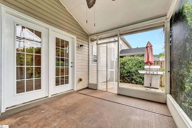 unfurnished sunroom featuring ceiling fan and french doors