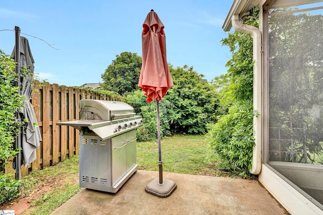 view of yard featuring fence and a patio