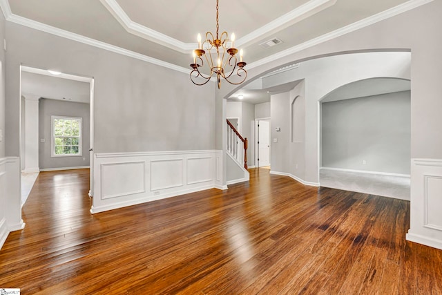 unfurnished dining area featuring arched walkways, a chandelier, hardwood / wood-style flooring, visible vents, and crown molding