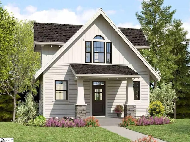 view of front of house with a front lawn, covered porch, a shingled roof, and board and batten siding