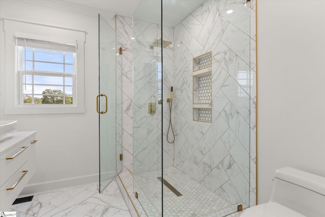 bathroom featuring vanity, toilet, marble finish floor, a marble finish shower, and baseboards
