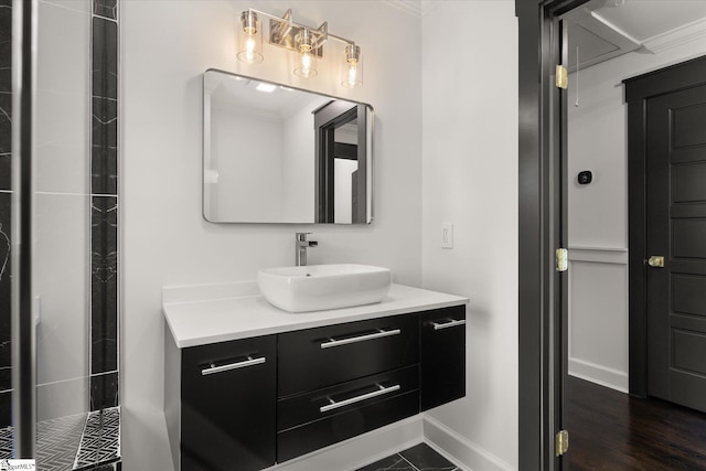 bathroom with crown molding, vanity, and baseboards