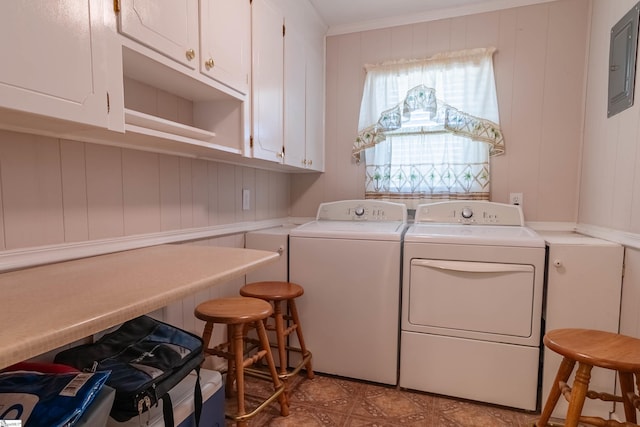 laundry area with ornamental molding, electric panel, cabinet space, and washing machine and clothes dryer