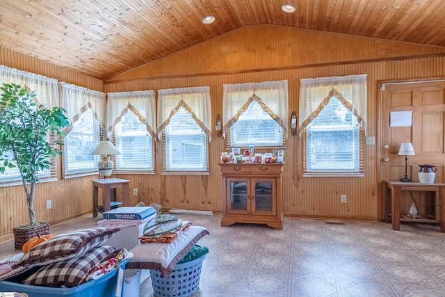 interior space featuring visible vents, wooden walls, and vaulted ceiling
