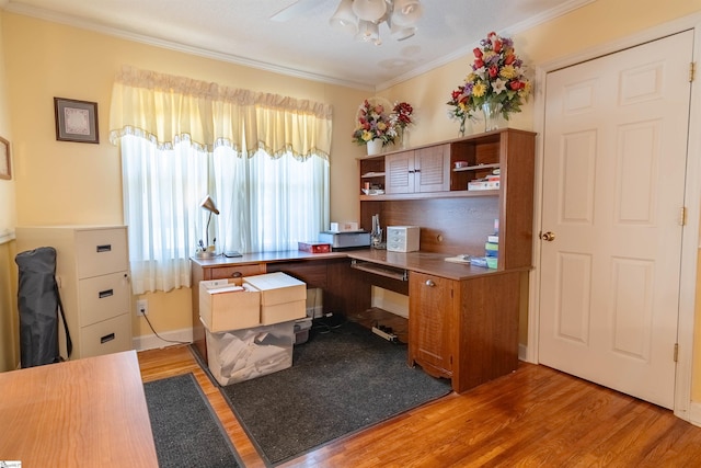 office with light wood-type flooring and ornamental molding