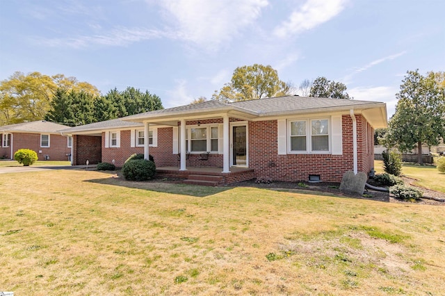 ranch-style home with a front yard, a porch, and brick siding