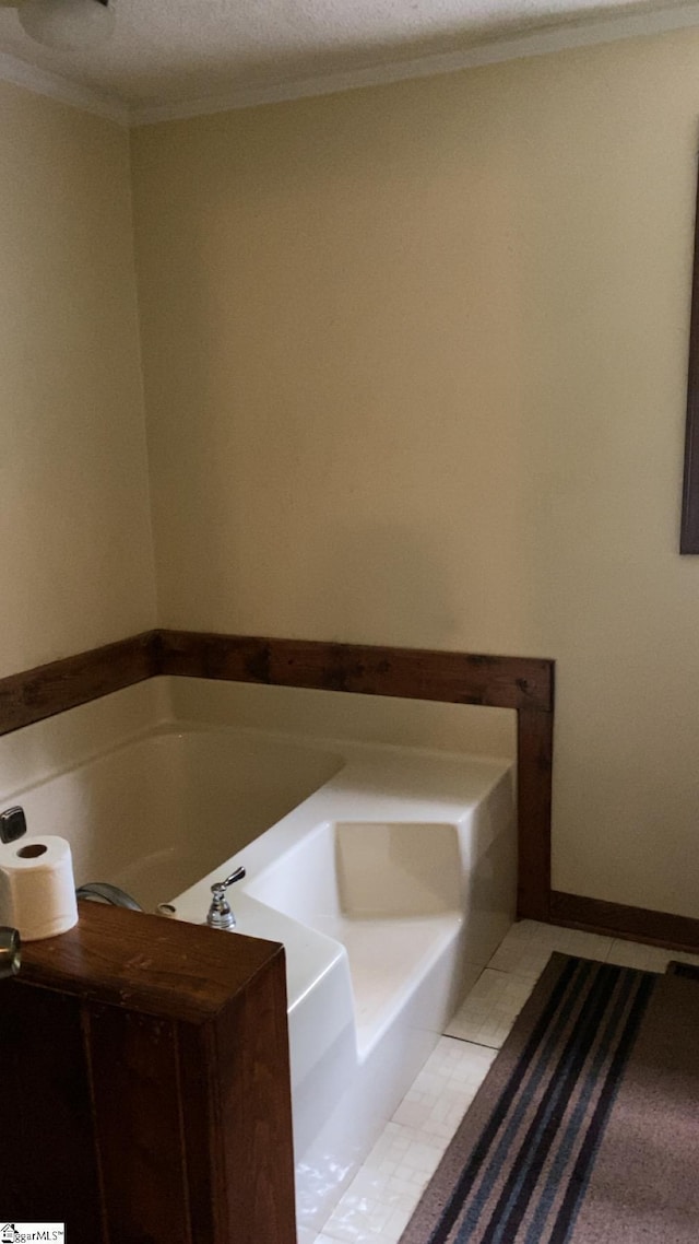 full bath with ornamental molding and a bath