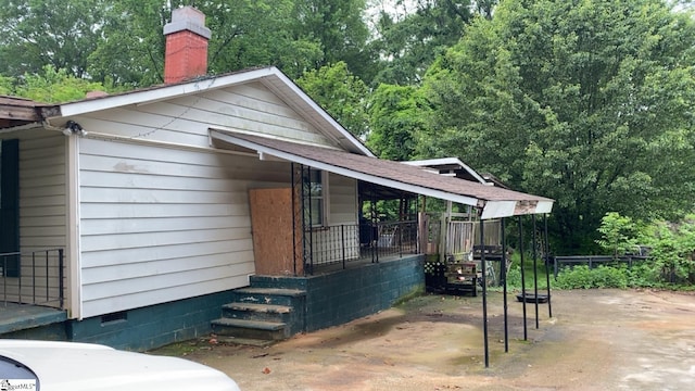 view of property exterior featuring a chimney and crawl space