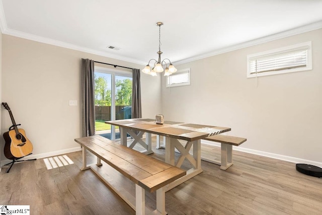149 Bruinen Dr, Fountain Inn, SC 29644 - dining room with visible vents, a chandelier, baseboards, light wood-type flooring, and ornamental molding