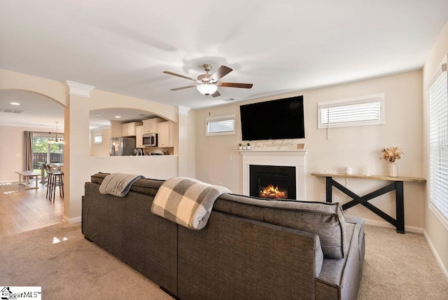 149 Bruinen Dr, Fountain Inn, SC 29644 - living room featuring light colored carpet, ceiling fan, a lit fireplace, and baseboards